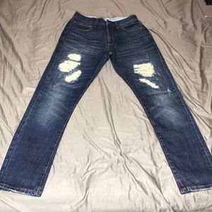 Raw distressed denim jeans